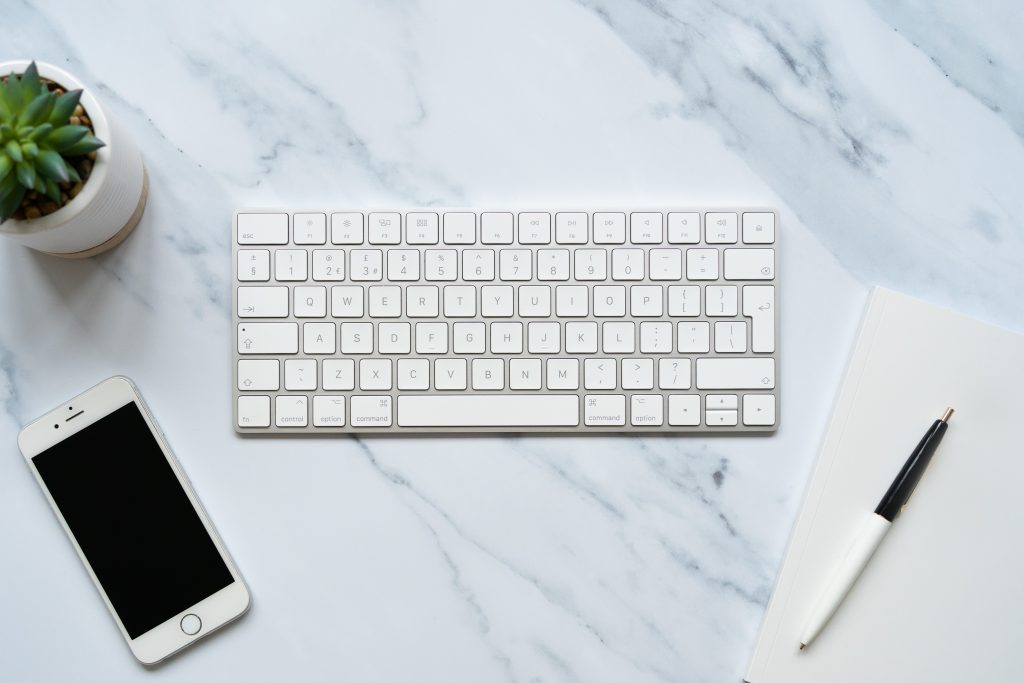 styled stock photography image of keyboard with notebook and mobile