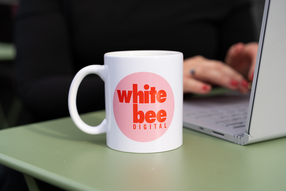 close up shot of White Bee Digital mug